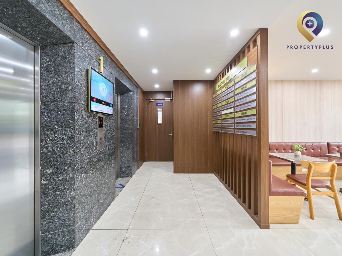 Ground floor lobby with wooden panel walls and elevator access in Au Viet Building